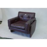 A designer purple leather armchair, 34" x 35", 30" high