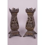 A pair of pierced brass square section vases on scroll supports, 10" high