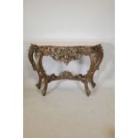 A carved giltwood console table with a marble top, 51½" x 15½", 34½" high