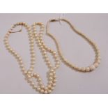 A graduated stone bead necklace and a faux pearl necklace