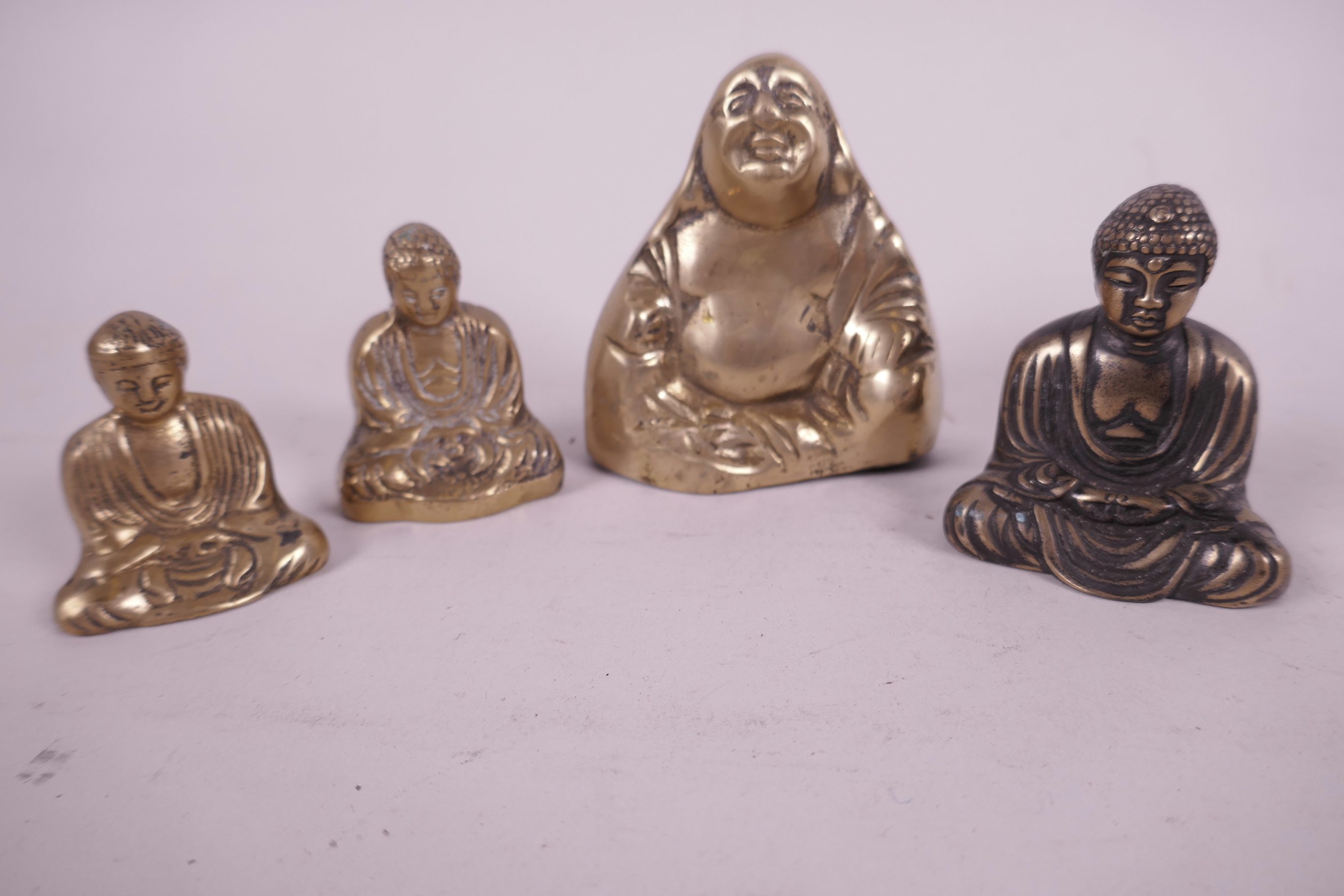 Four small cast brass figurines of Buddha seated in meditation, largest 3" high