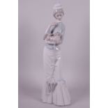 A tall Lladro porcelain figurine of a lady with Pekingese dog, 15" high
