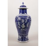 A Chinese blue and white porcelain jar and cover with decorative panels depicting a child carrying a
