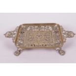 A pierced brass bonbon dish of rectangular form with two handles and raised on lion's paw