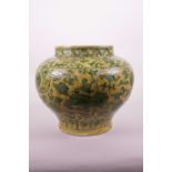 A Chinese yellow ground pottery vase with green enamel incised kylin decoration, 8½" high x 10"