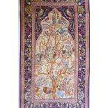 An Oriental wool and silk rug with blue borders and central design of exotic birds in a tree, 34"