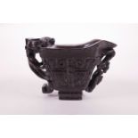 A Chinese faux horn libation cup with carved kylin decoration, 4 character mark to base, 3" high