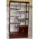 A Chinese hardwood display cabinet with open shelves and two door cupboard, 36" x 15" x 68"