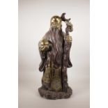 A large Chinese gilt and lacquered metal figure of Shao Lao with a peach, 4 character mark verso,