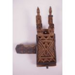 An African carved wood door latch/lock with figural decoration, 10" long