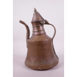 A C19th Eastern copper ewer with brass handles, 12½" high