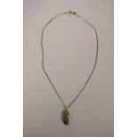 A Chinese gilt metal mounted jade pendant with dragon decoration on a gilt metal chain, 16" long