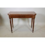 A Victorian mahogany tea table with a fold over top, raised on turned supports, 38" x 17½", 30" high