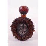 An amber style snuff bottle with carved cameo portrait decoration, 3" high