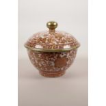 A Chinese red and white pot and cover with floral decoration and gilt highlights, seal mark to base,