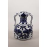 A Chinese two handled blue and white porcelain jug with floral decoration, 6 character mark to side,