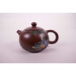 A Chinese Yixing teapot with enamel decoration of a fisherman, character inscription verso, seal