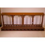 A C19th oak communion bench with carved and pierced decoration, 15" x 84" x 34"