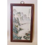 A large Chinese famille verte porcelain panel decorated with a mountainous riverside landscape,