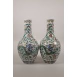 A pair of Chinese doucai porcelain bottle vases decorated with dragons and flowers, seal mark to