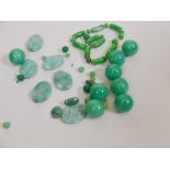 A collection of jade and faux jade beads and balls, large balls 1" diameter