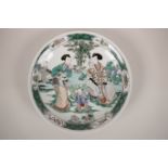 A Chinese famille verte porcelain dish decorated with women and children in a garden, 6 character