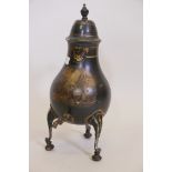 A C19th toleware tea urn raised on tripod supports with gilt decoration, 18" high