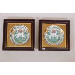 A pair of Continental porcelain dishes, with armorial crests and gilt highlights, set in gilt and