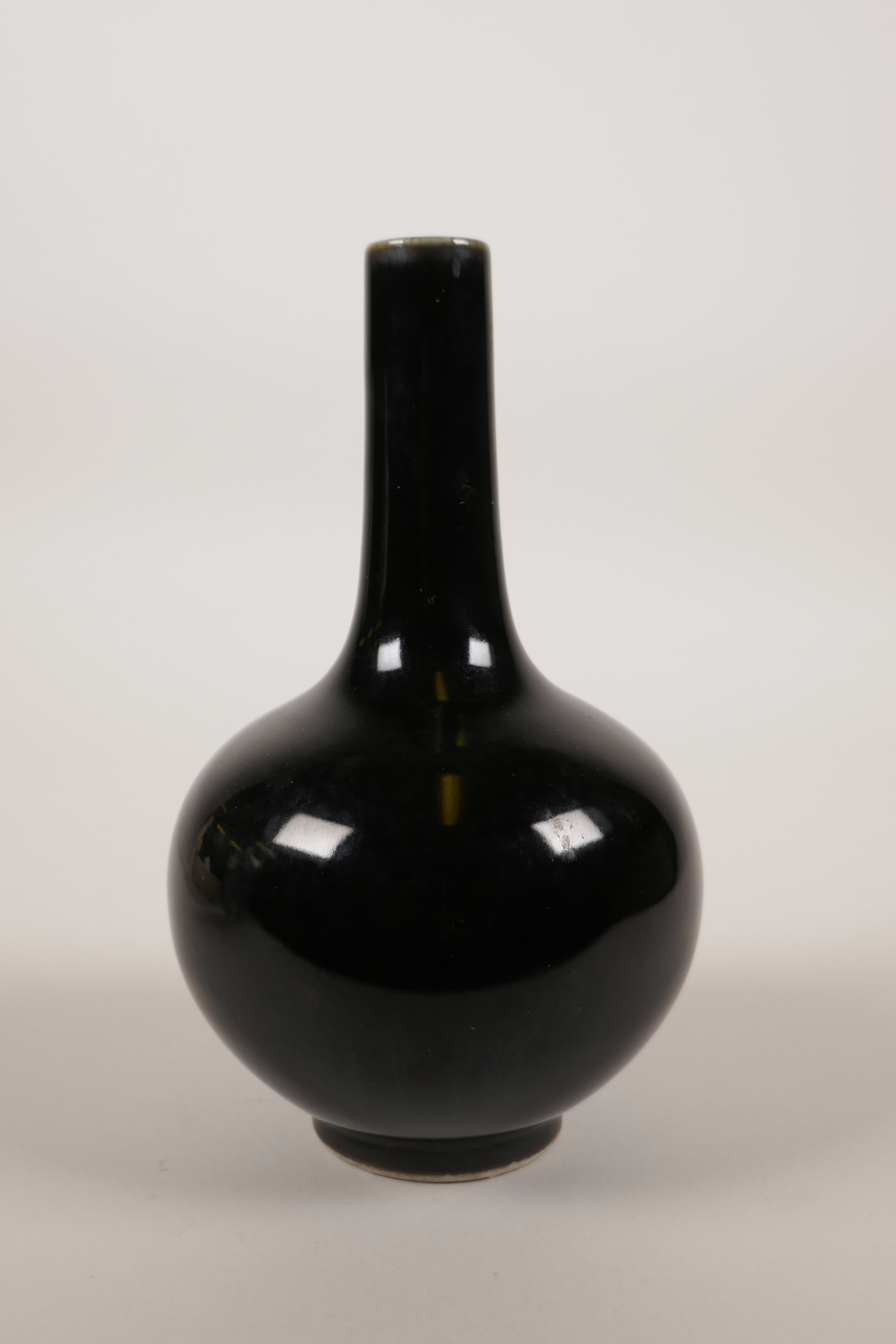 A Chinese black mirror glaze porcelain bottle vase, mark to base, 6½" high