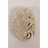 A Chinese carved mottled white jade pendant with dragon and Chan Chu decoration, 2½" long