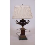 A brass mounted coloured stone table lamp with pleated silk shade, 24" high overall