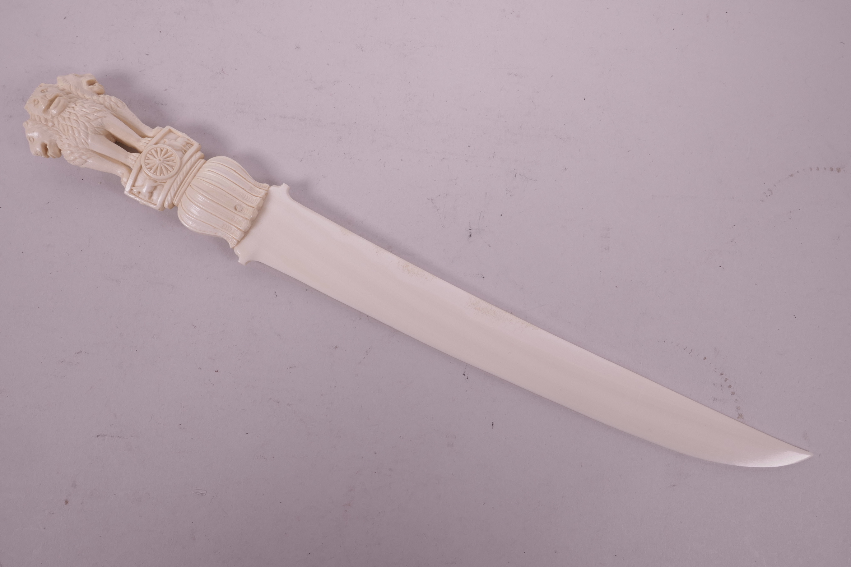 A late C19th/early C20th ivory letter opener, with carved handle in the form of three lions, 12"