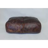 A large brown leather pouffe, 20" x 36"