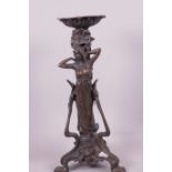 A cast bronze candlestick/lamp base in the Art Nouveau style cast as a lady surrounded by