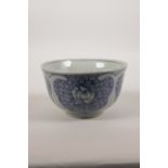 A Chinese blue and white pottery rice bowl with lotus flower decoration, 5" diameter
