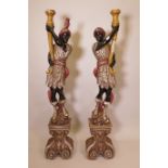 A pair of large floor standing carved and painted wood blackamoor figures, 64" high