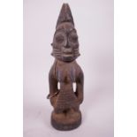 An African carved wood fertility figure, 9½" high