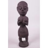 A West African fetish figurine of a woman, 10" high