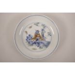 A Chinese doucai porcelain saucer dish decorated with a bearded warrior relaxing on rocks, 6