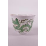 A Chinese porcelain tea bowl decorated with two green enamel dragons, 6 character mark to base, 2"