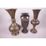 A Oriental bronze two handled vase, 10" high, and two Oriental embossed brass vases