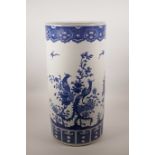 A large Chinese blue and white pottery cylinder stick stand decorated with Asiatic birds amongst
