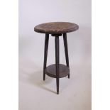 A Maori carved hardwood two tier occasional table, 27½" high, 17½" diameter