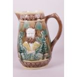 A large C19th majolica jug embossed with a portrait of a bearded gentleman, 9½" high