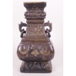 A Chinese cast bronze vase of rectangular form, the body cast with scrolls and geometric patterns,