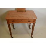 A Gillows style oak writing desk with flip up pen and ink compartment, and one frieze drawer