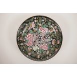 A Chinese famille noire porcelain cabinet plate decorated with butterflies amongst flowers, 4