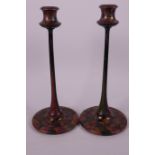 A pair of slender lacquered candlesticks with geometric decoration, 10½" high