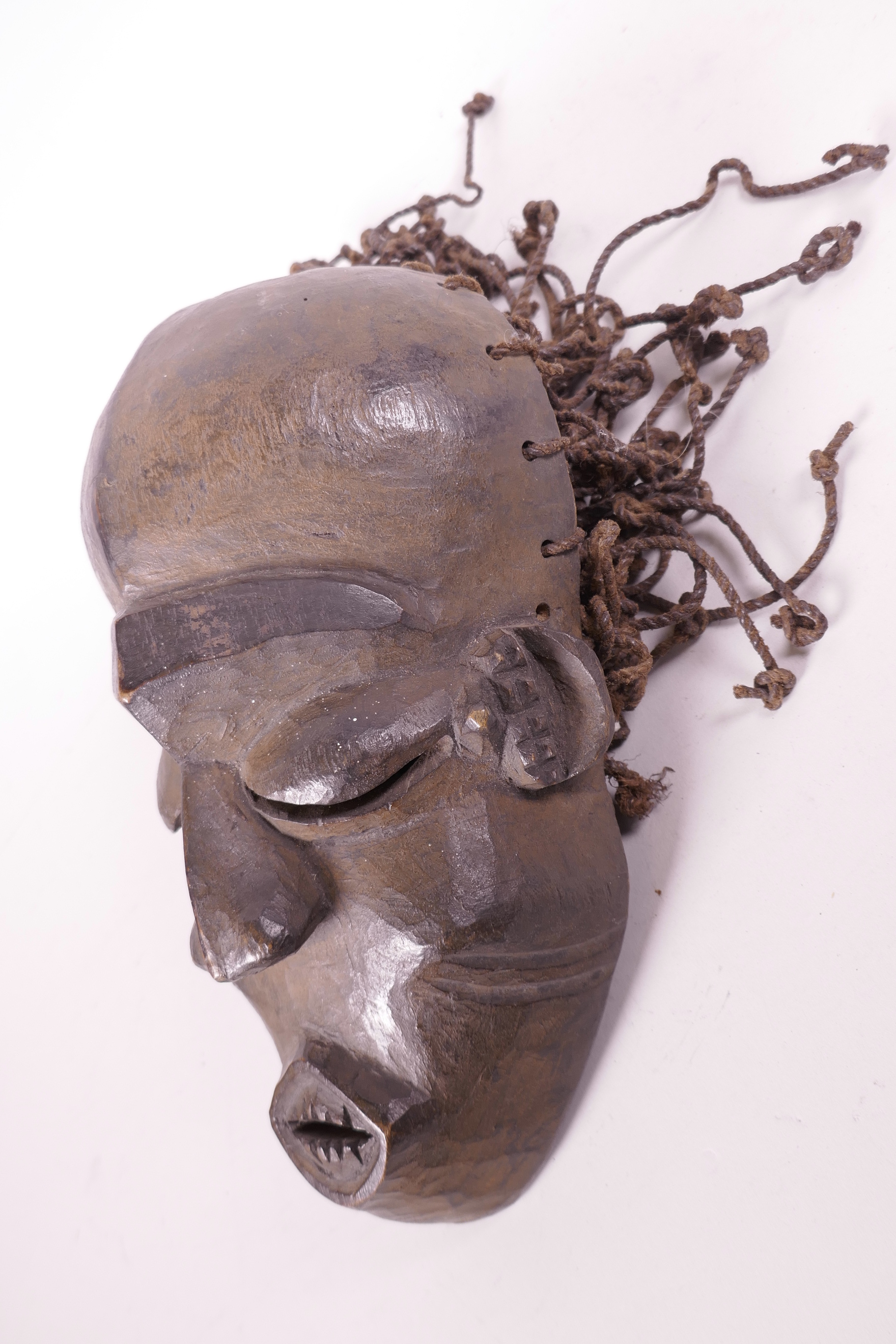 An African carved wood tribal mask with string hair, (Ivory Coast), 9½" long - Image 2 of 2