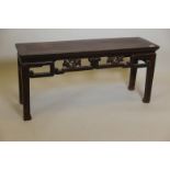 A C19th Chinese elm altar table with carved and pierced frieze, 42" x 12" x 19"